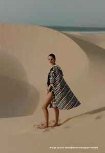 Model standing in desert