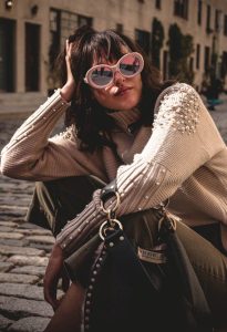 Girl-in-sitting-pose-with-shades-and-handbag-in-hand