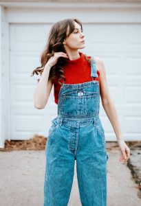 Girl-wearing-red-crop-top-and-denim-overalls