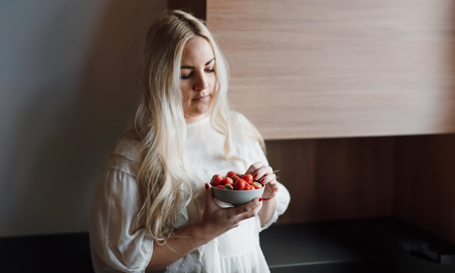 Woman with strawberries in hand