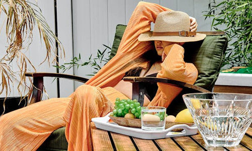 Woman-with-hat--sitting-near-fruits