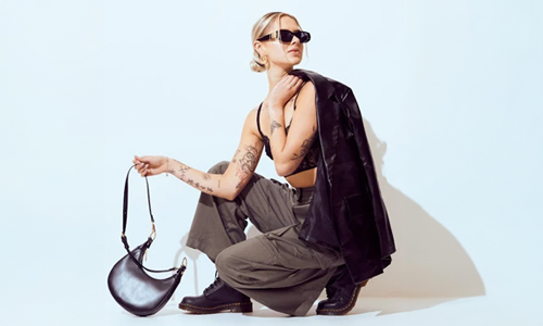 woman-posing-with-black-leather-jacket-and-purse