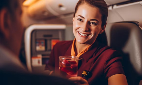 Woman-inside-airplane-with-drink-in-hand