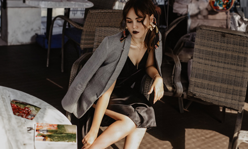 Women-layering-a-blazer-upon-black-dress