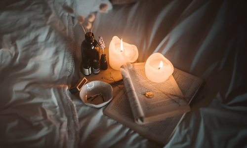 Aromatherapy oils and candles in bed
