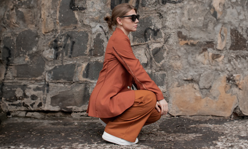 Woman in orange suit with sunglasses