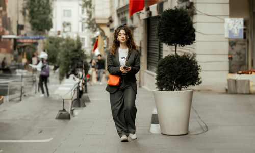 Women wearing green suit and tan handbag