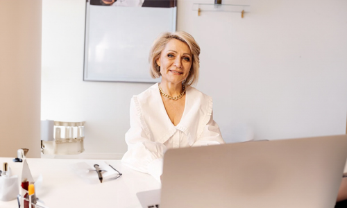 Woman in white dress wearing chunky necklace