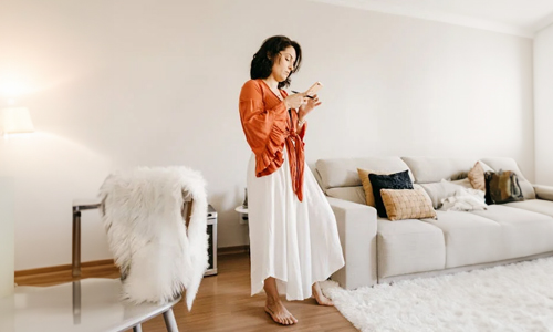 Women wearing orange top and white skirt