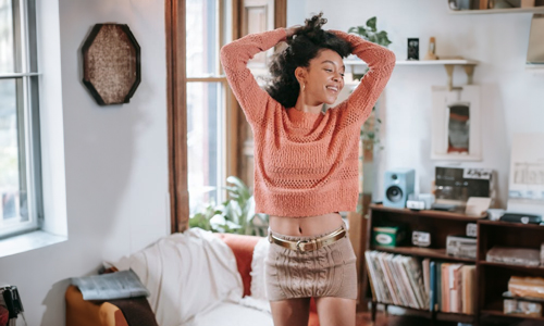 Women wearing knit sweatshirt and mini skirt