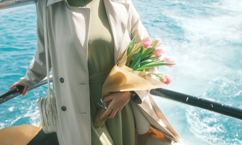 women-standing-with-flowers-in-hand