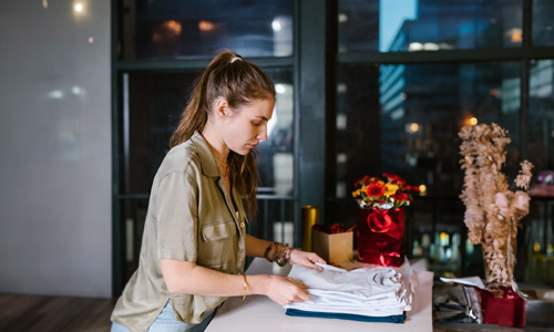 Woman folding t-shirts