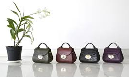 Handbags-arranged-near-a-flower-pot