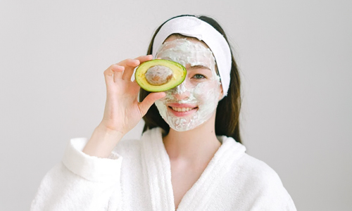 Woman-with-face-mask-and-avocado