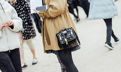 Women-wearing-statement-coat-and--a-handbag