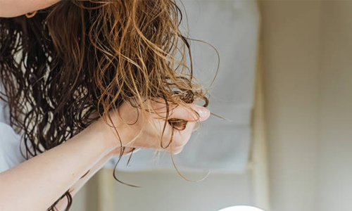 Woman defining her curls
