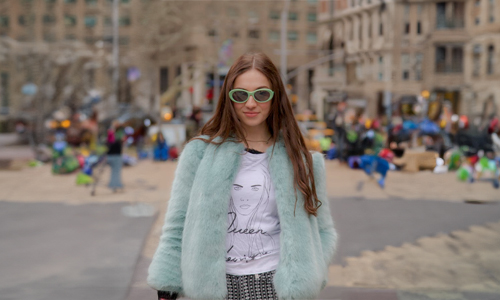 Women wearing green coat and glasses
