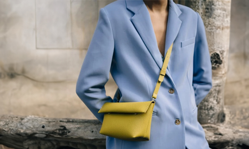 Blue-suit-and-green-purse