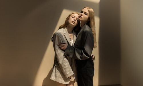 2 women wearing tailored suits