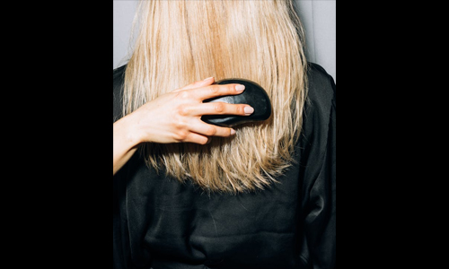 small black brush in blonde hair