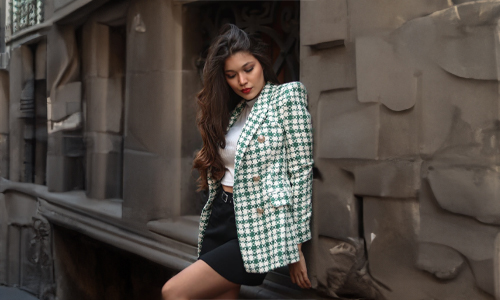 Woman wearing green checkered blazer