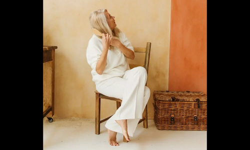 Old woman combing her hair