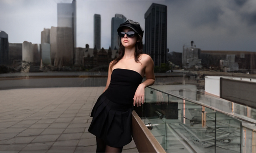 Woman wearing black dress and hat