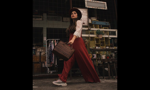 Women wearing burgundy jumpsuit