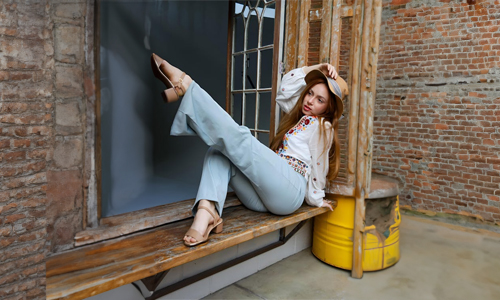woman in a hat sitting on a bench