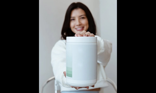 Woman holding Collagen powder