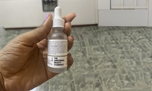 Person holding serum bottle