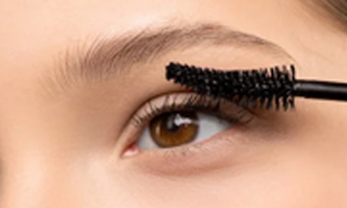  Woman applying mascara