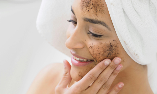 Woman scrubbing face