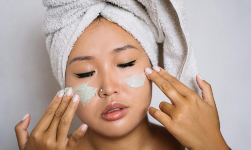 Woman-applying-moisturizer