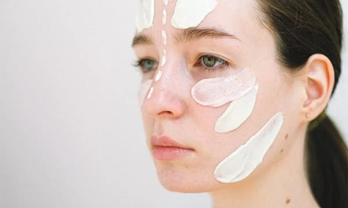 Woman applying sunscreen