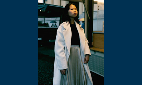 Woman wearing white coat and skirt