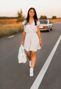 Smiley woman walking away from car