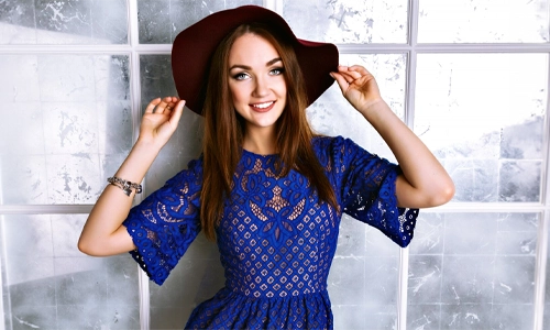 Woman styling a navy blue dress with fashionable accessories