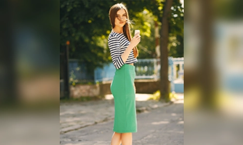 Woman wearing a green outfit paired with colorful wedge sandals for a bold summer look