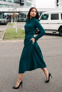 Woman wearing a green dress styled with elegant footwear