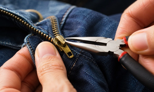using pliers to tighten a loose zipper slider