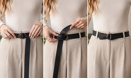 Hands threading a canvas belt through two metal D-rings and securing with a double-loop fastening.