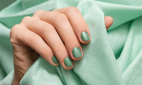 hand with pistachio manicure showing versatile skin-tone match