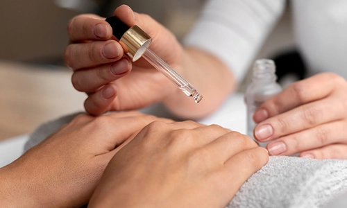 image of a cuticle oil applied during manicure for a moisturized look