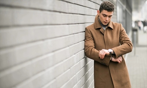 a man wearing gabardine brown coat