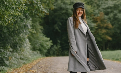 model wearing a gray gabardine coat made of traditional fabric