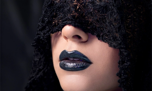 woman wearing a black lipstick with bare skin